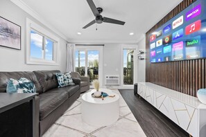 Bright, stylish living room with ocean views, a smart TV, and a private balcony.