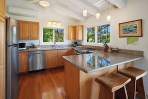 Kitchen is equipped with pots, pans, utensils and appliances