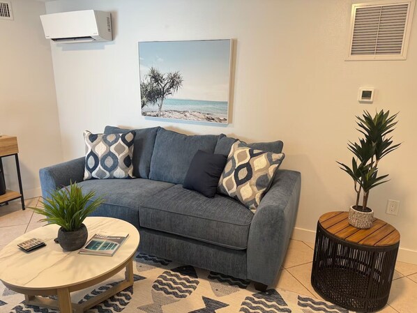 Living room with queen sofa bed and smart tv