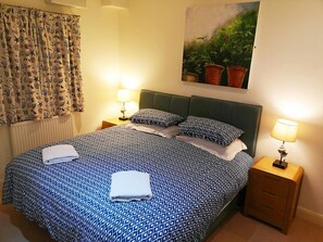 Bedroom with super king size bed, bedside tables and lamps
