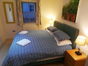 Bedroom with super king size bed, bedside tables and lamps