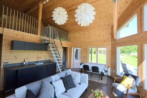 Sofas, armchair, kitchen area, dining table and chairs