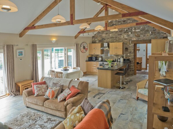 Open plan living room with French windows