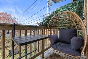 Enjoy a cozy outdoor escape on this charming balcony—perfect for a morning coffee or a peaceful afternoon with a view!