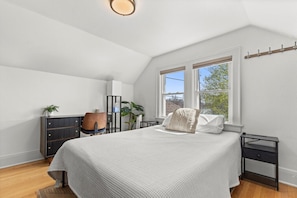 Relax and recharge in this cozy queen bedroom, complete with a dedicated workspace for when you need to catch up on work or emails