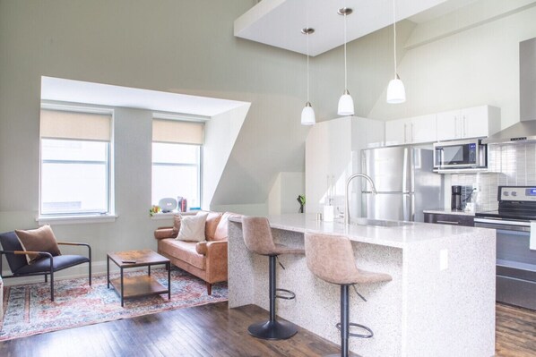 Living room and kitchen with bar stool seating