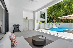 Lounge in style on the sun-drenched patio, where a spacious seating area and gas BBQ invite you to savour alfresco feasts, sip cocktails, and soak in the tranquil coastal ambience.