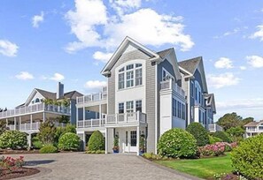 Stunning coastal home just one house from the ocean, featuring elegant architecture and lush landscaping.