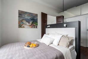 There is a 160cm wide bed in the same space with the apartment kitchen with a wall separating it from the dining area