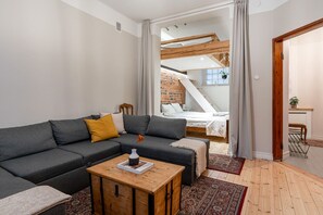 The living room of the apartment has access to a sleeping alcove. The living room also has a sofa bed.