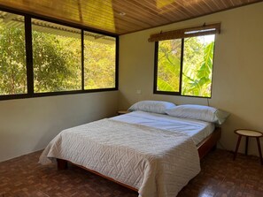 Bedroom has three windows - all with jungle views. 