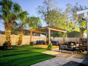 Cozy up under the pergola — your perfect outdoor escape awaits.