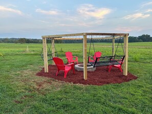 Fire pit with seating and two swings
