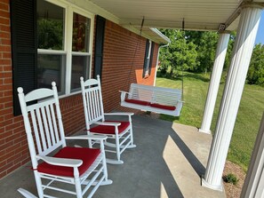 Front porch with rocking chairs and a porch swing