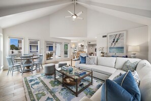 Coastal comfort meets stylish space in the main living area with vaulted ceiling