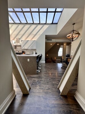 A dramatic skylight fills this penthouse apartment with natural light and has a view of the clocktower above