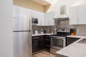 Kitchen with bar stool seating and a dining/work table
