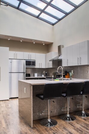 A dramatic skylight fills this penthouse apartment with natural light and has a view of the clocktower above