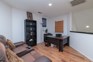 Loft office with desk, chair and double recliner.