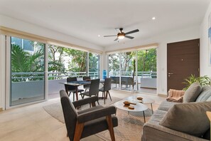 Unwind in this cozy living room with a sofa bed, A/C, balcony access & water.