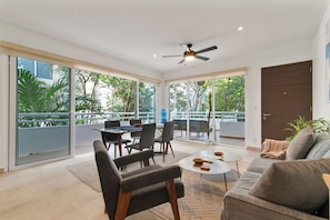 Unwind in this cozy living room with a sofa bed, A/C, balcony access & water.
