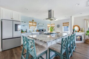 Fully stocked with kitchen supplies with Barstools all around the kitchen island (6 seats)