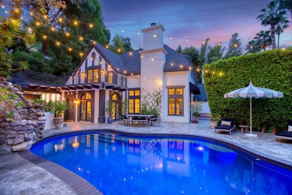 Serene pool view at dusk, reflecting the evening sky.