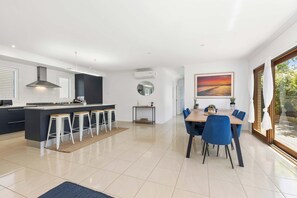 The north-facing living, dining, and kitchen area is filled with natural light, creating a bright and airy space to unwind