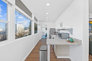 Enjoy cooking in this sleek, modern kitchen with all essentials provided.