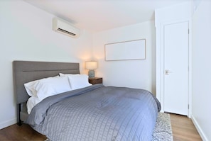 Unwind in this serene and comfortable bedroom with plush bedding.