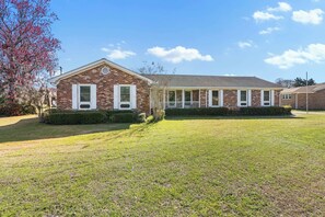 Spacious brick home with classic charm, a large front yard, and inviting curb appeal — perfect for your next getaway! 