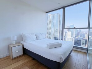 The master bedroom with a queen-sized bed and plush pillows.