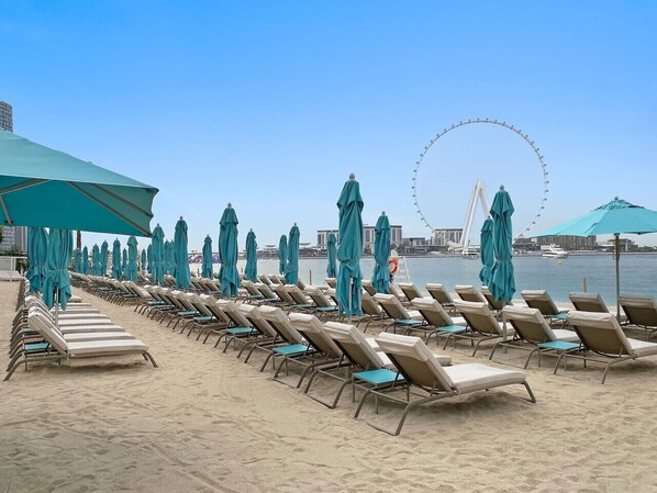 Beachfront Oasis: Delight in sun-soaked loungers with breathtaking views of the iconic wheel!
