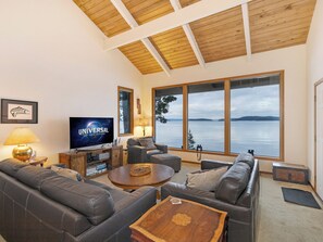 Sunken Living room has floor to ceiling windows viewing Shaw Island. There's a DVD/CD player and a Smart TV (no regular tv reception)