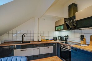 The fully equipped kitchen with modern appliances.