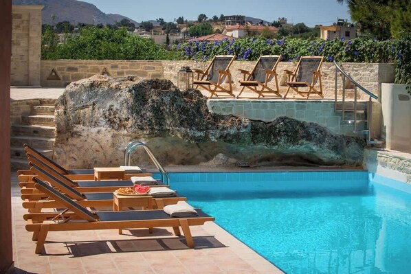 View of the pool and the patio with the natural rock.