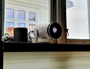 Smart projector connected to bluetooth speaker. Stream from youtube or Netflix, or cast from your phone.