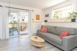 Living room with view of your private outdoor patio. The couch can be made into a second bed.