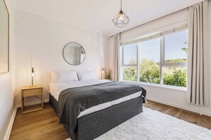 Recharge in the primary bedroom, featuring a queen bed and built-in storage to keep your space clutter-free.