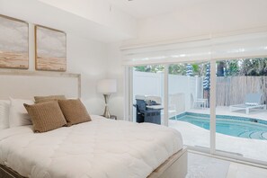 Ground-floor master bedroom with pool and backyard access.