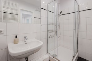 Clean and modern bathroom with a glass shower and fresh towels.