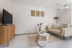 Living area with couch and smart TV.