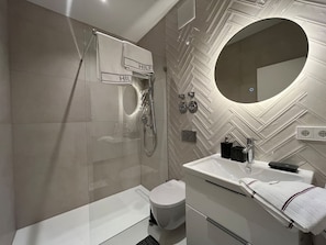 The bathroom with a walk-in shower.