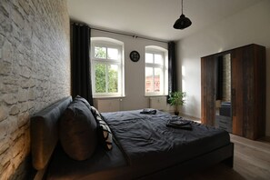 The cozy bedroom with the double bed features a large wardrobe with plenty of storage space.