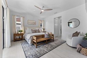 Spacious primary suite with king bed and calm, coastal style