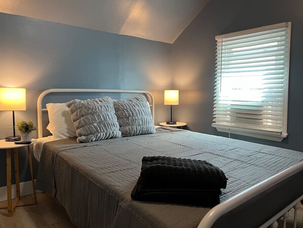 The bedroom’s serene ambiance invites you to relax, with a plush bed that promises a restful night's sleep.