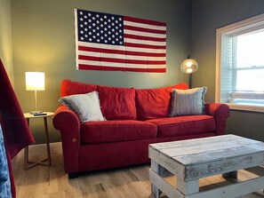 The living room’s cozy vibe makes it the perfect spot to relax, with ample seating and a warm ambiance.