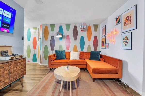 Groovy vibes and far-out charm in this retro-inspired living room - where neon signs and funky patterns take center stage!