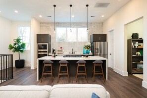 Kitchen: Modern elegance with a spacious marble island and bright natural light—perfect for dining!