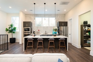Kitchen: Modern elegance with a spacious marble island and bright natural light—perfect for dining!
